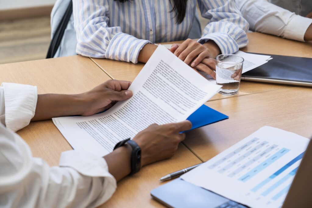 Facilities managers analyzing the paperwork involved with an RFP.